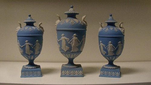 A garniture of three Wedgwood blue jasper vases and covers, each of the ovoid bodies sprigged with t