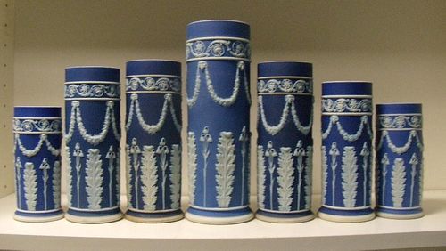 A garniture of seven early 20th century Wedgwood blue jasper spill vases, each with floral swags sus
