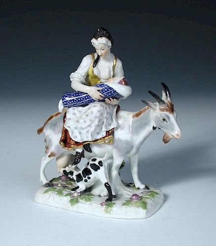 After Eberlein, a Meissen figure of the Tailor's wife, she suckles her child while riding a goat in