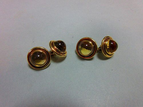 A pair of citrine set double ended cufflinks, each end with a round cabochon pale gold citrine colle