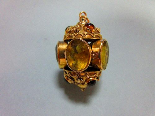 An ornate citrine set pendant, designed as five oval cut and collet set lemon citrines forming a hol