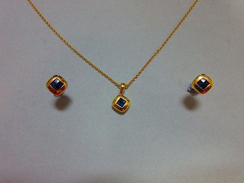 A mystery set sapphire and 18ct gold suite of pendant and earstuds by Wempe, the pendant and each ea