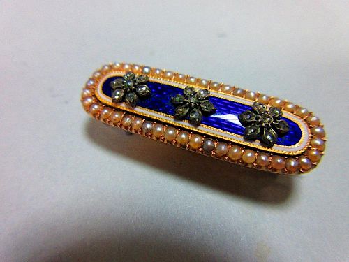 A Georgian diamond, seed pearl and enamel brooch, of elongated oval form and closed back setting, de