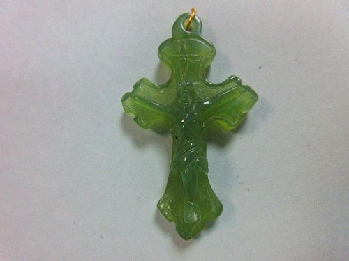 A carved green hardstone crucifix pendant, the treflee form cross with incised edge decoration and s
