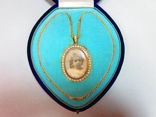 A pearl and enamel miniature frame pendant necklace in fitted case, the oval double-sided frame deco