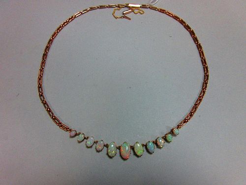 A graduated opal necklace, set to the front with an articulated line of eleven oval cabochon opals t