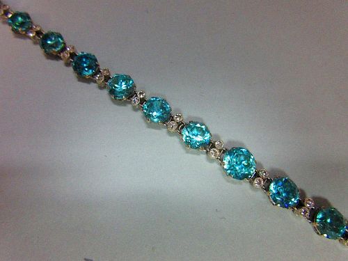 A blue zircon and diamond bracelet / necklace, composed of fifteen graduated round cut blue zircons