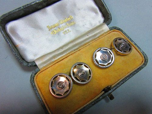 A pair of diamond set double ended cufflinks, each 1.5cm diameter end designed as a stylised wheel w