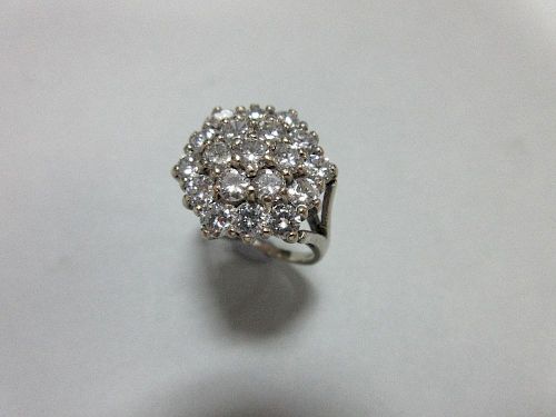 A diamond cluster ring set in 18ct gold, closely set with nineteen round brilliant cut diamonds in a