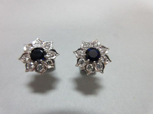 A pair of sapphire and diamond cluster earstuds, each designed as a flowerhead with a round cut sapp