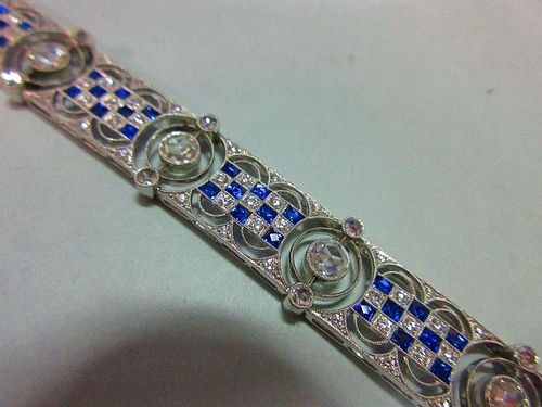 An art deco diamond and sapphire bracelet, designed as nine geometric pierced panels with a central