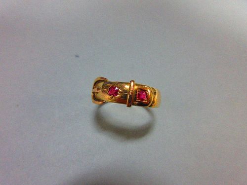 A Victorian 15ct gold buckle ring set with rubies, the two stones, one oval cut the other round cut,