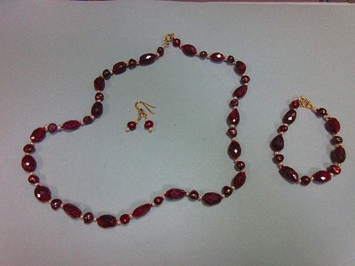 A ruby and pearl suite, the necklace and bracelet, which may be worn individually or continuously, c