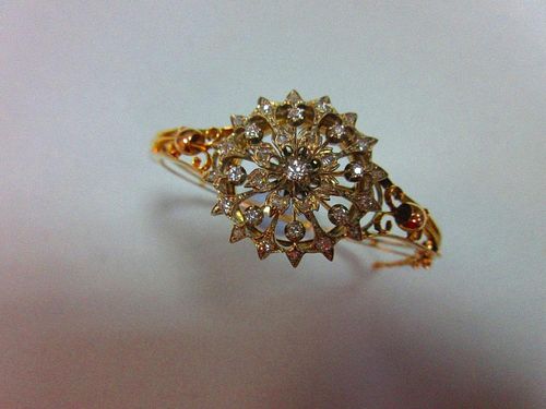 A Victorian diamond set hinged bangle / brooch, the bangle formed by knife-edge bars flaring at the