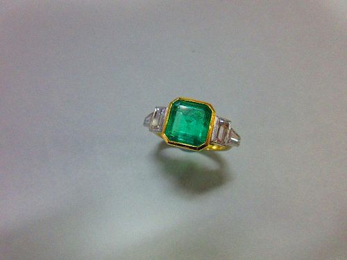 An 18ct gold emerald and diamond ring by Theo Fennell, the near-square emerald cut emerald, estimate