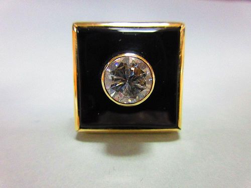 A 2ct diamond, onyx and gold modern handmade designer ring, the round brilliant cut diamond collet s