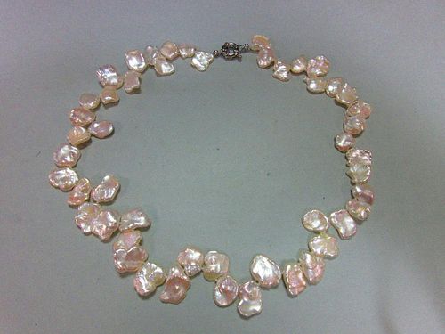 A 'cornflake' cultured pearl necklace, the creamy white flake-shaped pearls individually knotted, le