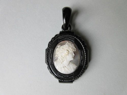 A Victorian carved jet mounted shell cameo pendant, the white on grey cameo depicting a Bacchante in