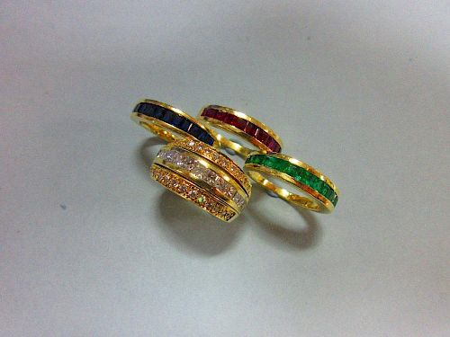 An interchangeable diamond, ruby, emerald and sapphire half band eternity ring, with four independen