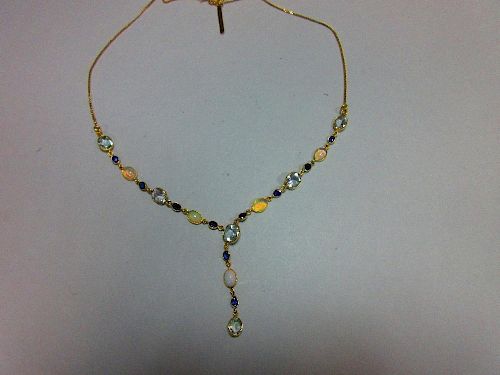 An 18ct gold opal, sapphire and aquamarine necklace, set to the front with an articulated line of sp
