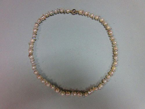 A contemporary pearl necklace, composed of oval white pearls alternating with pale dove grey flake p