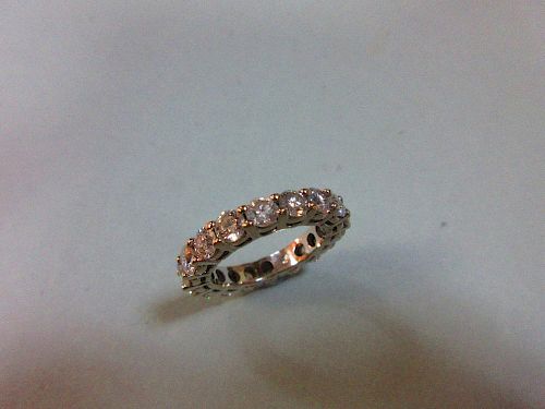 A diamond full hoop eternity ring, set with eighteen round brilliant cut diamonds in white precious