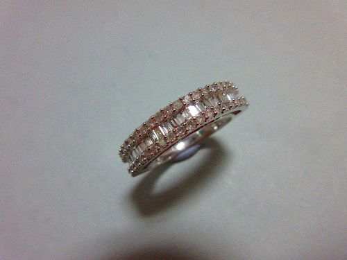 A white gold and diamond half hoop ring, with a channel set line of baguette cut diamonds between cl