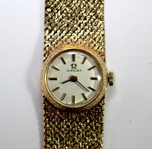 By Omega - a lady's 9ct gold cased wristwatch, the round silvered dial with baton numerals, calibre
