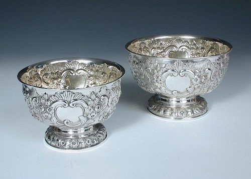 A small matched graduated pair of Edwardian silver rose bowls, one by Charles Stuart Harris, London