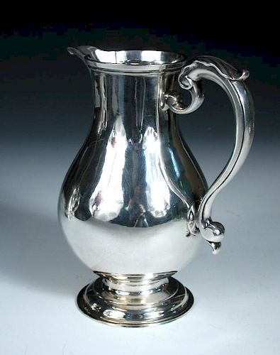 A George II silver ale jug, by Thomas Whipham, London 1775, of plain baluster shape, with leaf cappe