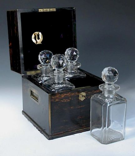 A 19th century calamander decanter box, the rising top opening to reveal four period cut glass decan