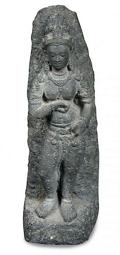A Gandharan schist goddess, possibly Hariti and 2nd-3rd century AD, she stands draped only in jewels