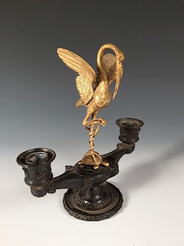 A 19th century French gilt metal and bronze candelabra, with a stork and serpent standing on a torto