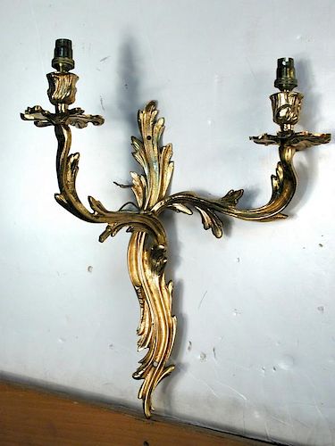 A set of four Rococo style gilt metal wall lights, the twin-branch lights with scroll-work backs (4)