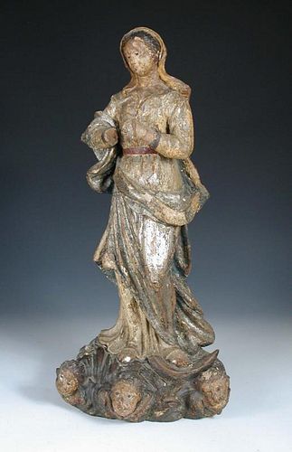 An 18th century carved wood polychrome figure of the Madonna, possibly Spanish, she wears a blue lin