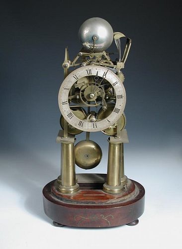 A Victorian brass bell chiming skeleton clock, the four tapering column legs supporting the twin fus