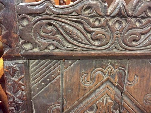 An early 17th century oak wainscote chair, carved in the Medieval style with celtic designs, mask ar