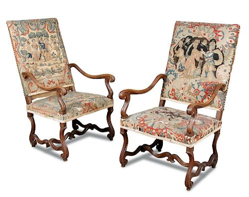 A pair of 19th century Continental walnut framed armchairs, upholstered backs and seats with needlew