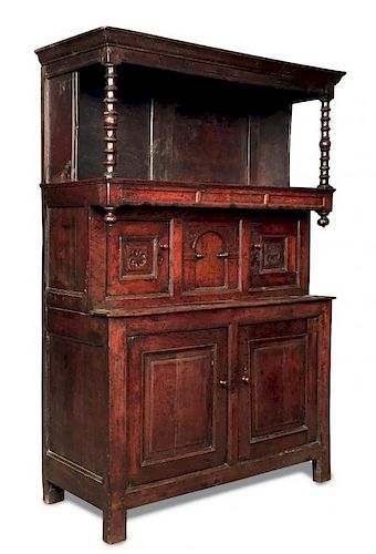A late 17th century oak tridarn, with open front overhung shelf to the top supported by turned colum
