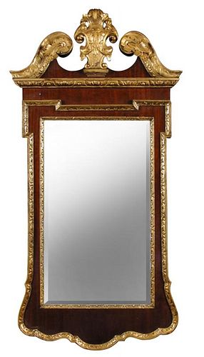 A George II style mahogany and parcel gilt pier glass, with break arch pediment and cartouche shaped