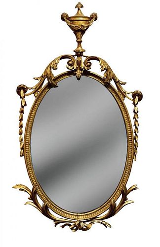 An 18th century style gilt framed wall mirror, of neo-classical design with urn finial, leaf and swa