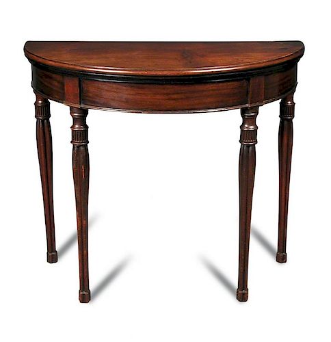 A George IV mahogany demi lune card table, with foldover top, green velvet lined interior, on cluste