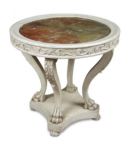 A Baltic painted and carved wood gueridon, the circular top inset with rouge marble, supported on fo