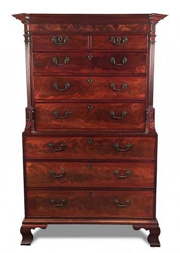 A George III mahogany chest on chest, with a dentil moulded cornice, canted column sides, cast handl