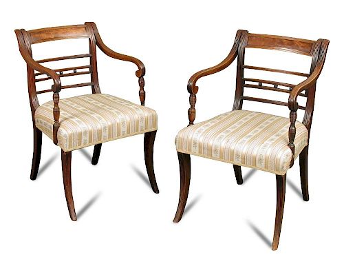 A Pair Regency mahogany bar back elbow dining chairs, with ebony line inlays, the reeded arms on vas