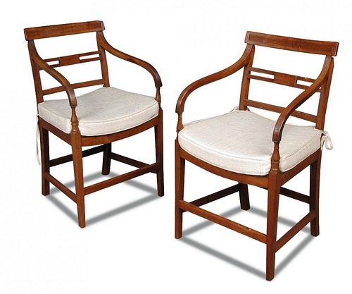 A pair of Regency fruitwood elbow dining chairs, with reeded bar backs and dished panel seats, with