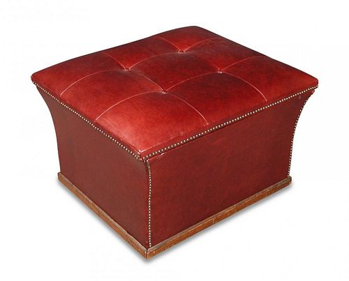 A red leather and brass studded ottoman stool, buttoned seat, on wheel casters 46 x 73 x 63cm (18 x