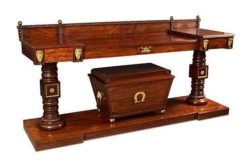 A 19th century mahogany serving table with integral wine cooler, with gilt mounts, raised back with