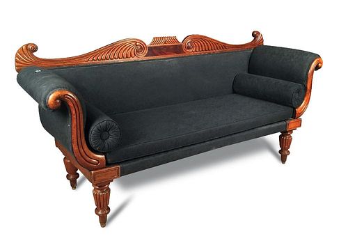 A late Regency mahogany sofa, scroll and gadroon carved show wood, upholstered in a black fabric wit