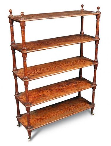 A late 19th century Oregon pine shelf, of five open tiers, with turned finials and on turned feet an